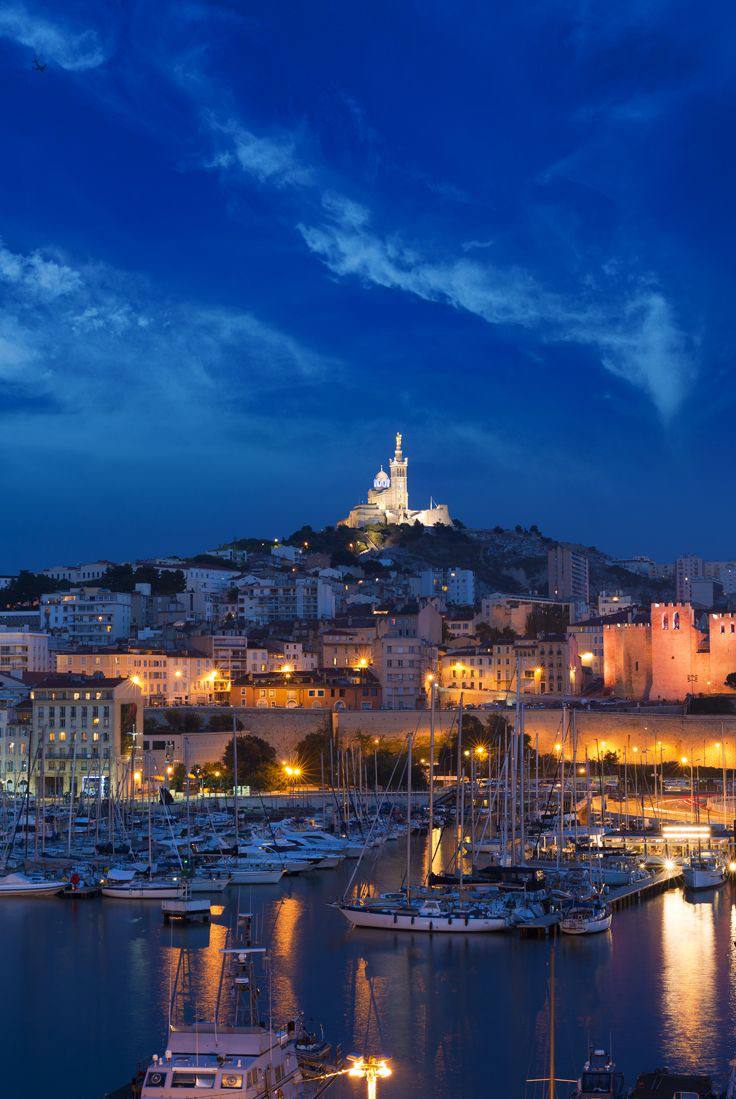 Old port of Marseille with Notre-Dame de la Garde at night
